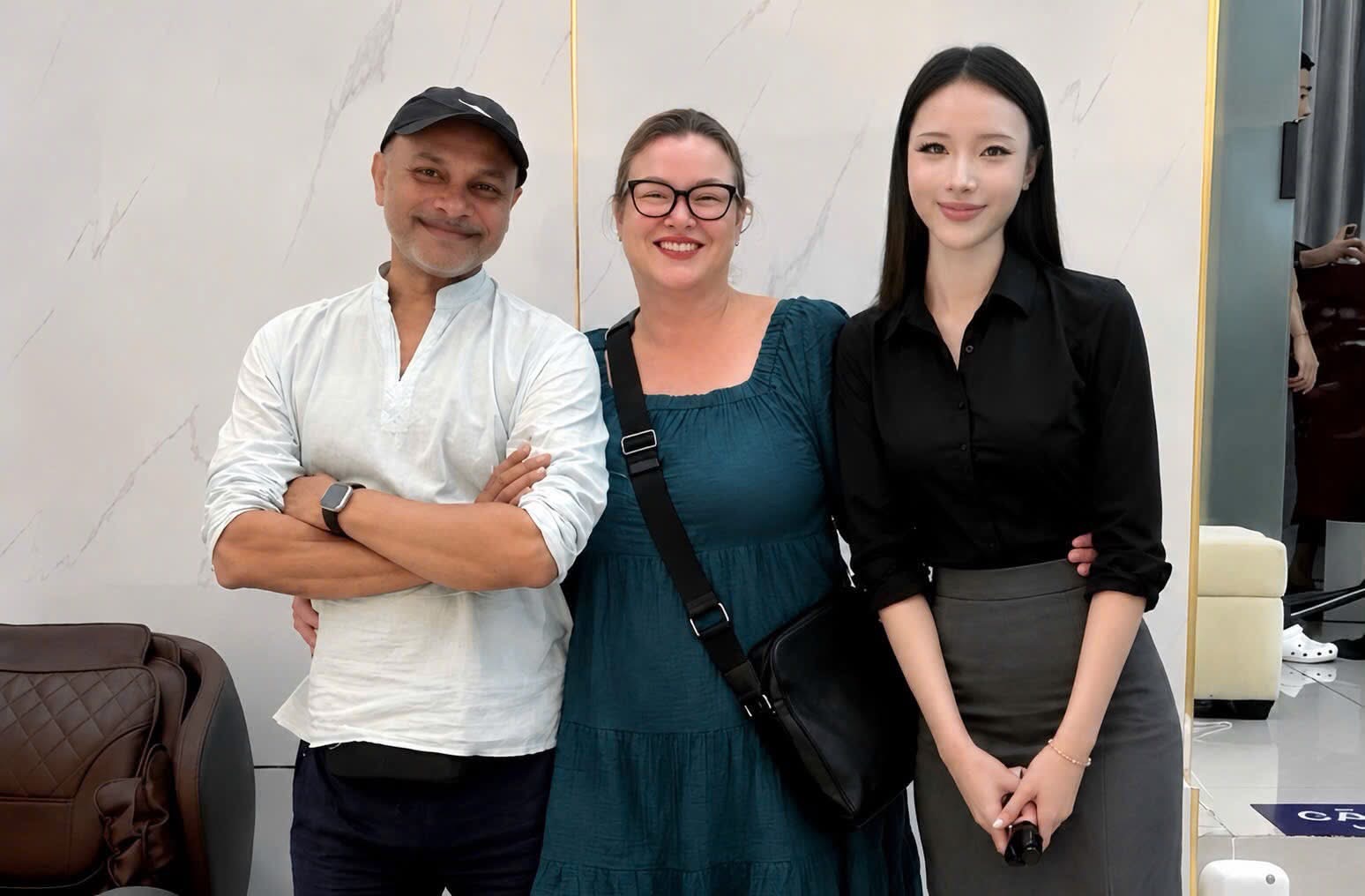 Chloe standing beside two guests at the clinic